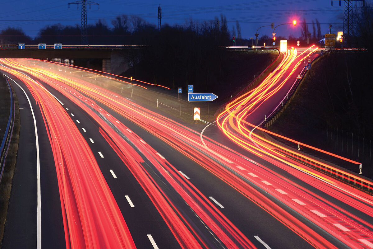 In a nighttime photo, streams of red light from vehicles line a highway in the Hannover region of Germany.