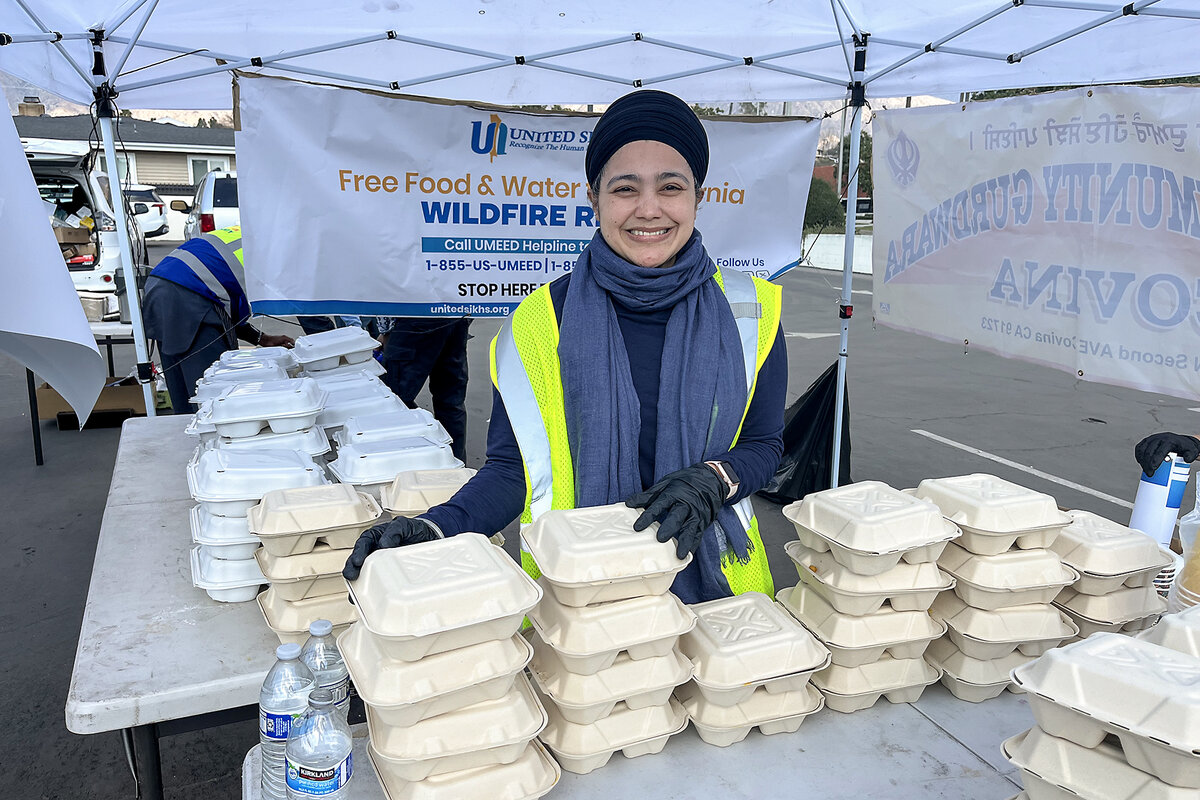 Meetan Kaur stands amid containers of chana masala and rice to help fire victims in Pasadena, California.