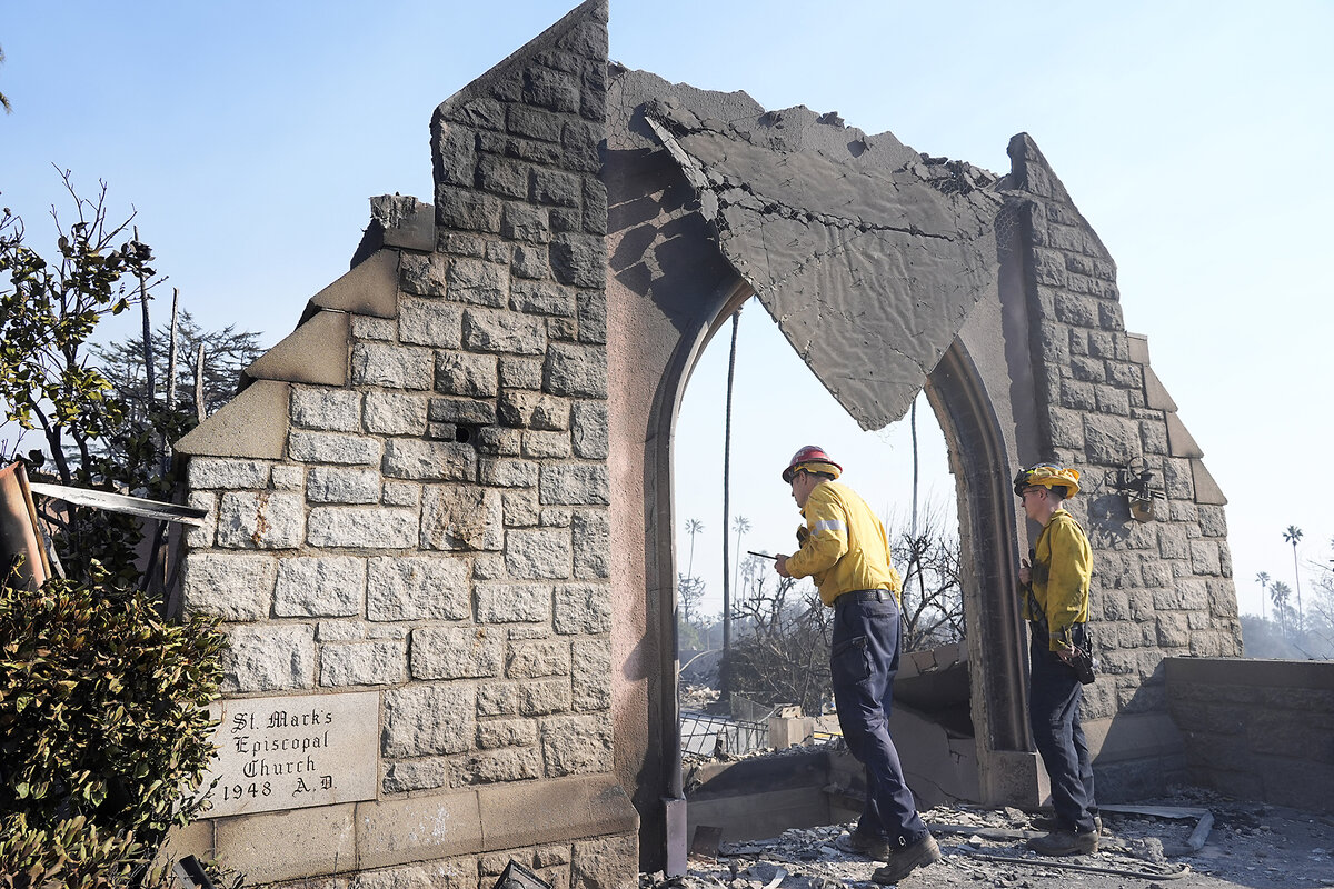Firefighters stand next to a burned wall that is all that's left of St. Mark’s Episcopal Church in Altadena, California.