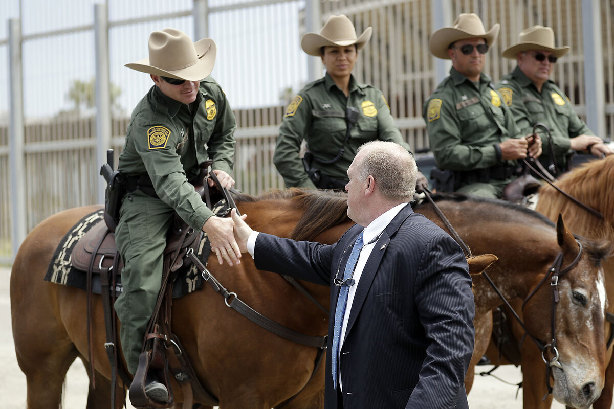 Tom Homan shakes hands with Border Patrol agents on horses along the U.S.-Mexico border.