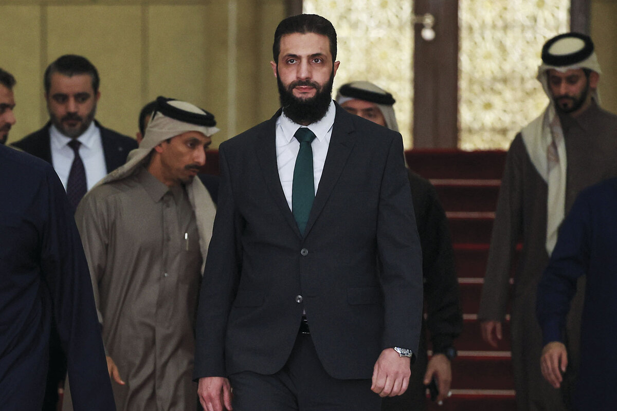 Ahmed al-Sharaa, the current leader of Syria, walks down a hallway in Damascus.