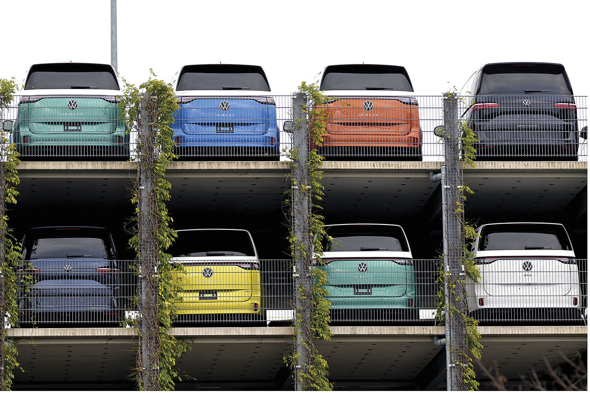 Two rows of Volkswagen electric buses are parked in a garage in Hannover, Germany.