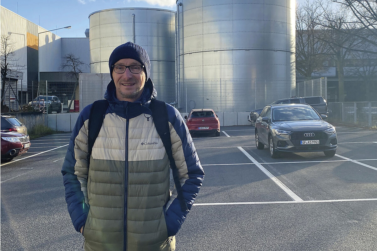 Machinist Lothar Herrmann stands in a Volkswagen factory parking lot in Braunschweig.