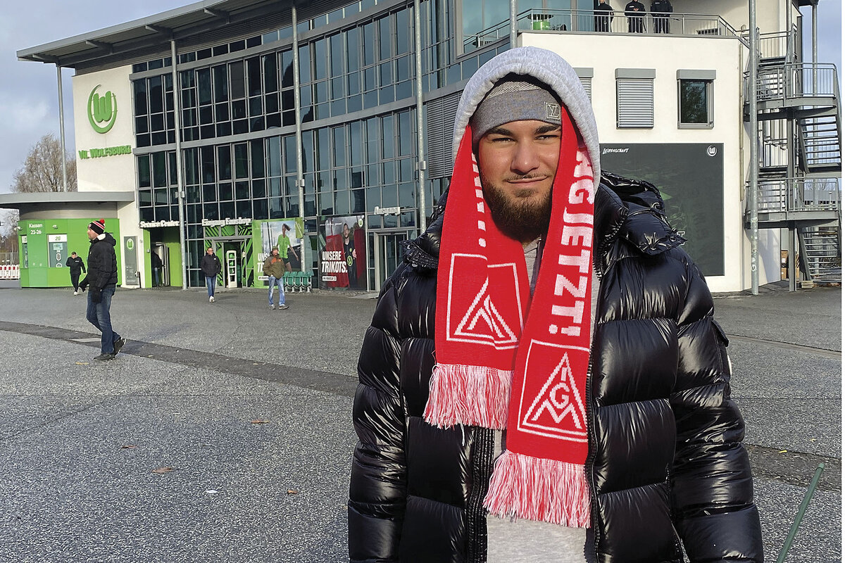 Leon Kamali, a newly qualified Volkswagen apprentice, stands outside a building, dressed in winter apparel.