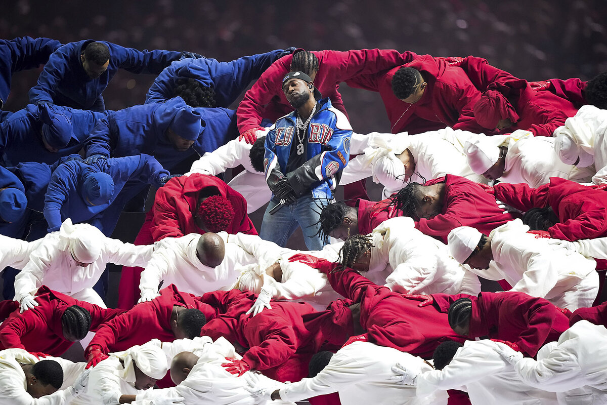 Rapper Kendrick Lamar performs at Super Bowl 59 halftime surrounded by dancers dressed in red, white, and blue.