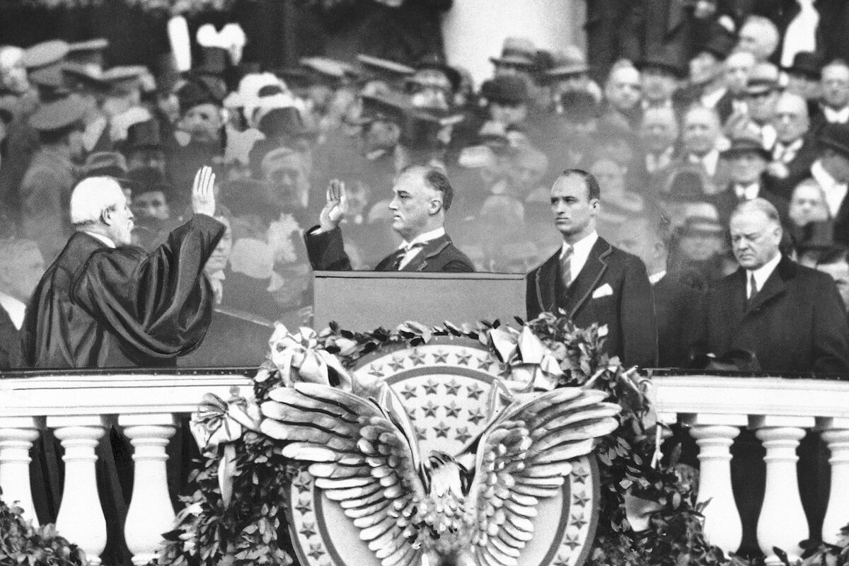 President Herbert Hoover stands by as President-elect Franklin D. Roosevelt takes the oath of office at his inauguration.