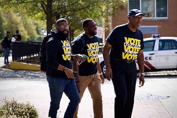 Courtland Cox, on the right, and two other activists wearing t-shirts reading vote at Morehouse College in Atlanta.