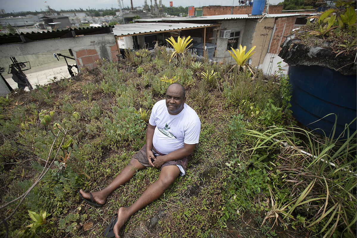 Luis Cassiano sits on his roof, which has been planted with mostly low-growing greenery, in Rio de Janeiro in 2020.