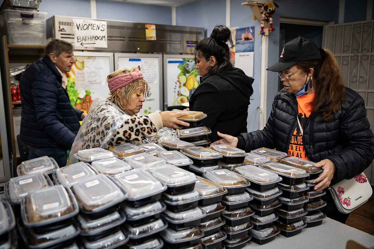Porfiria Guerrero, right, and other volunteers stack plastic containers with pre-made lunches. The food was donated for wildfire survivors and volunteers at the Pasadena Community Job Center site Feb. 12, 2025, in Pasadena, California.