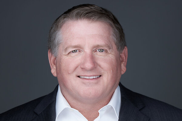 Mike Shires, chief of staff at the University of Austin, faces the camera and smiles