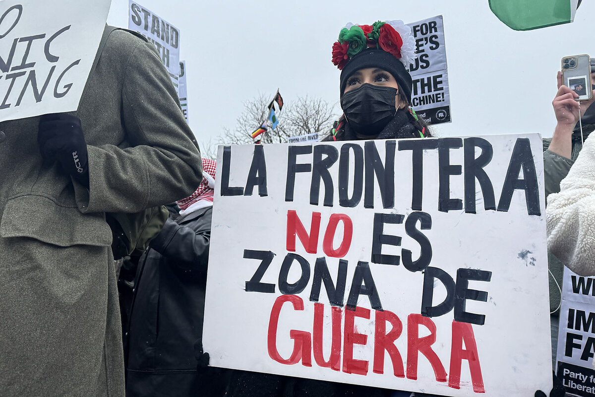 Protesters show support for immigrants and hold signs at a rally in Aurora, Colorado. 