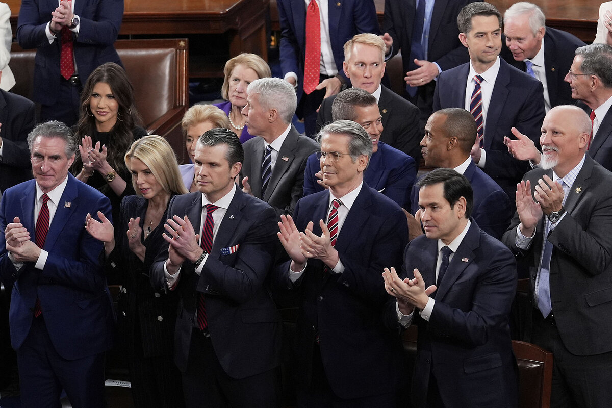 Trump Cabinet members applaud as they listen to the president's speech to Congress.