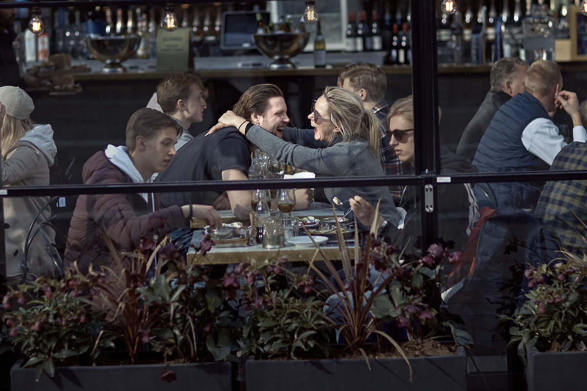 People sit at restaurant tables.