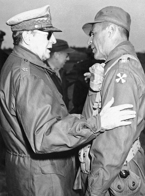 Gen. Douglas MacArthur, commander in chief, United Nations forces in Korea (at left), is greeted by Lt. Gen. Matthew B. Ridgeway at Kangnung, Korea on April 3, 1951. 