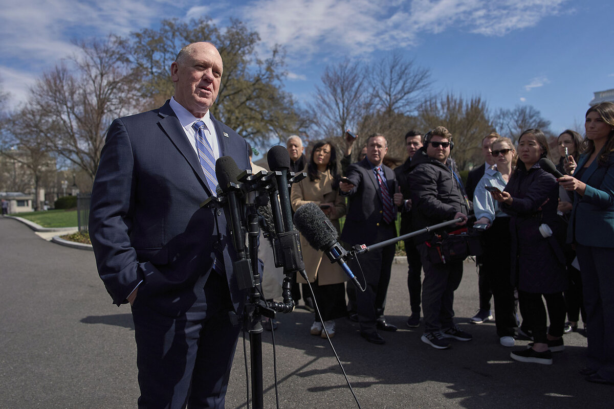 Tom Homan, in a blue suit, speaks with reporters outdoors at the White House.