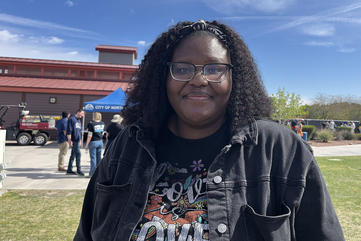 Angela Dorsey stands outdoors as she attends an anti-Trump rally.