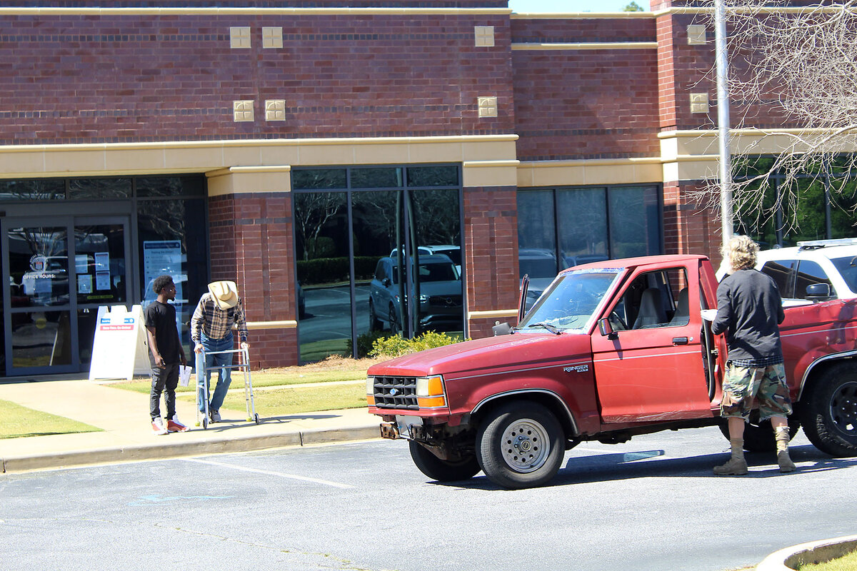 Two people walk out of the brick Social Security building in Columbus, Georgia.