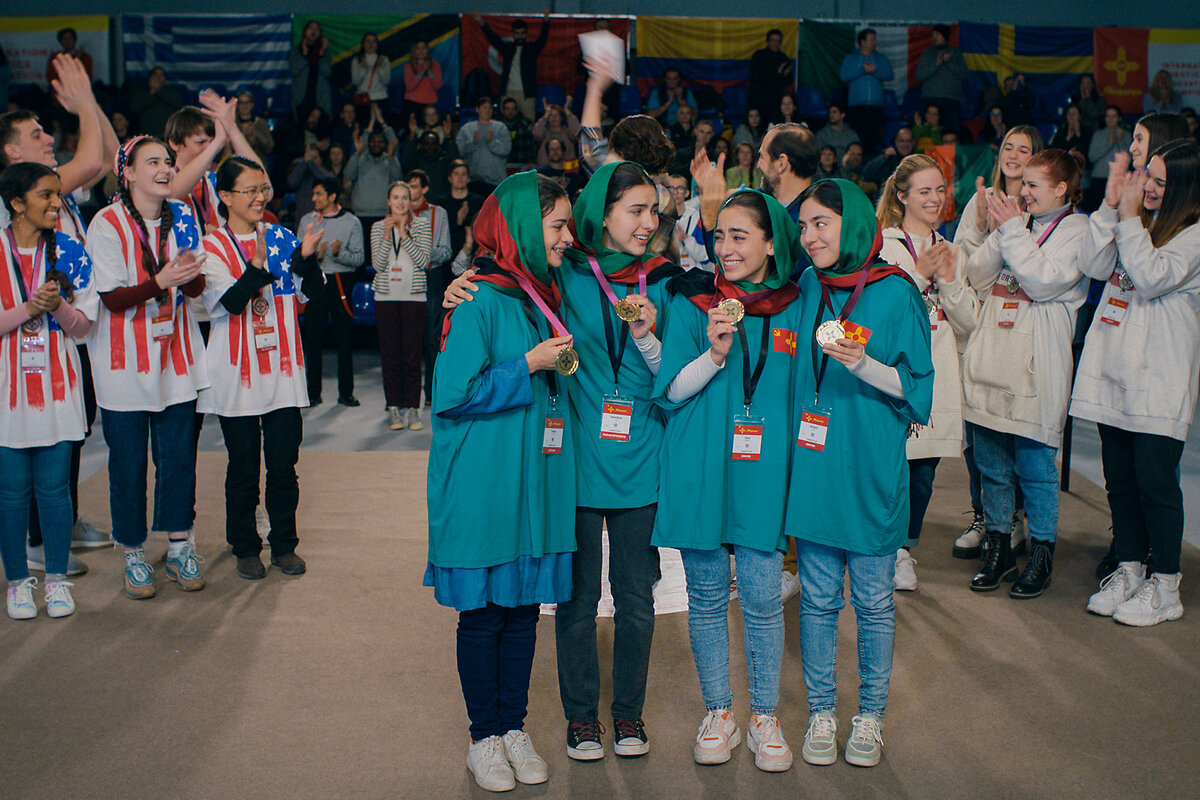 Actors portraying the Afghan girls robotics team stand together after an awards ceremony