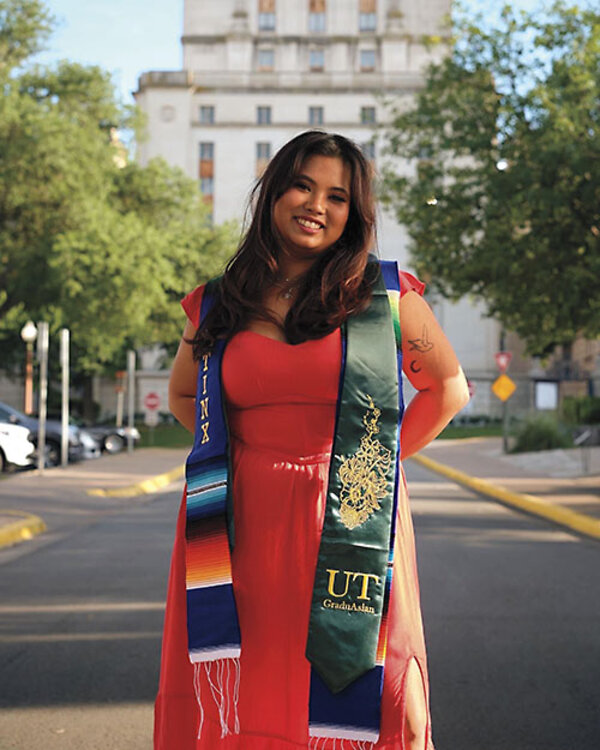 University of Texas at Austin student Amanda Garcia stands outside and looks at the camera smiling 