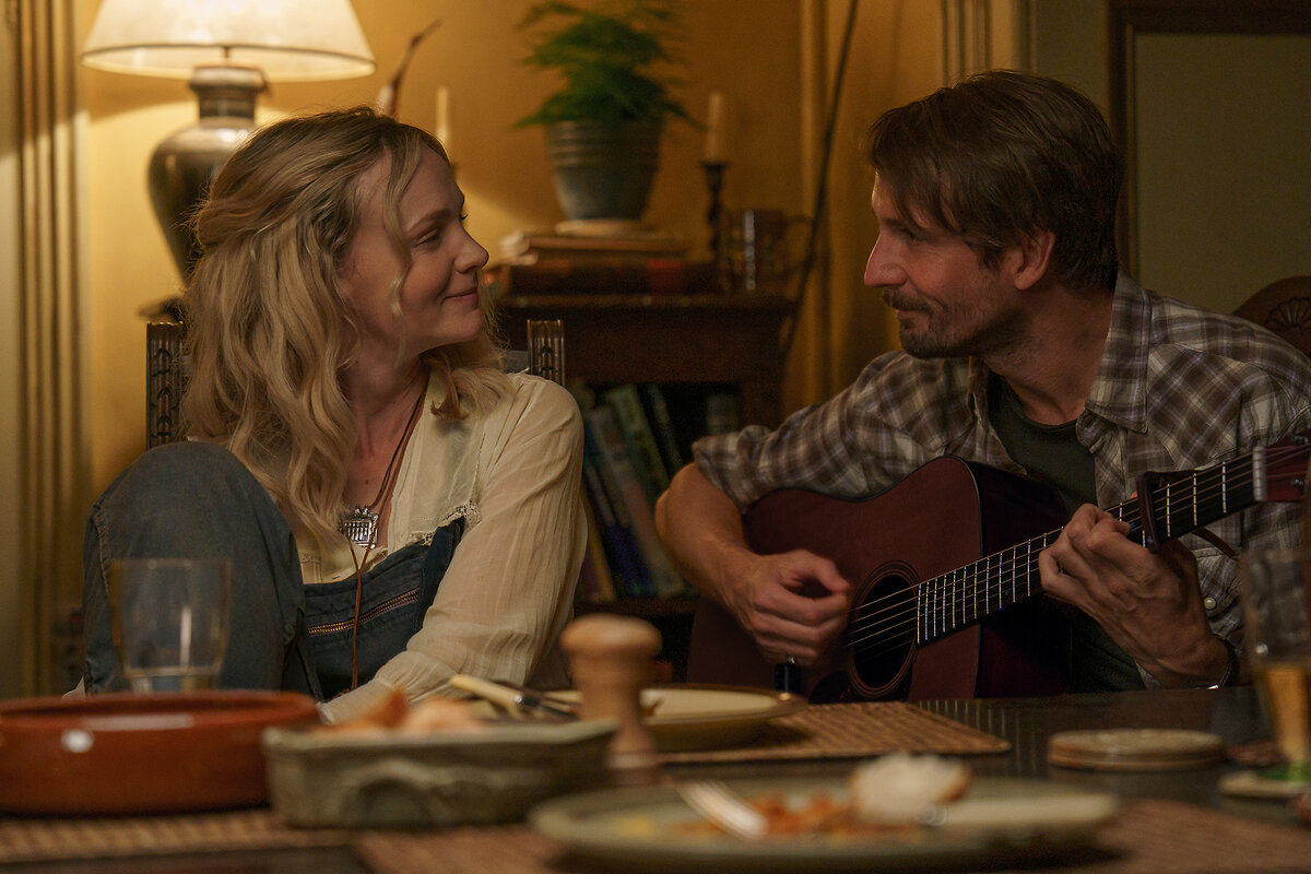 Actors Carey Mulligan and Tom Basden smile at each other in a scene from 'The Ballad of Wallis Island.'