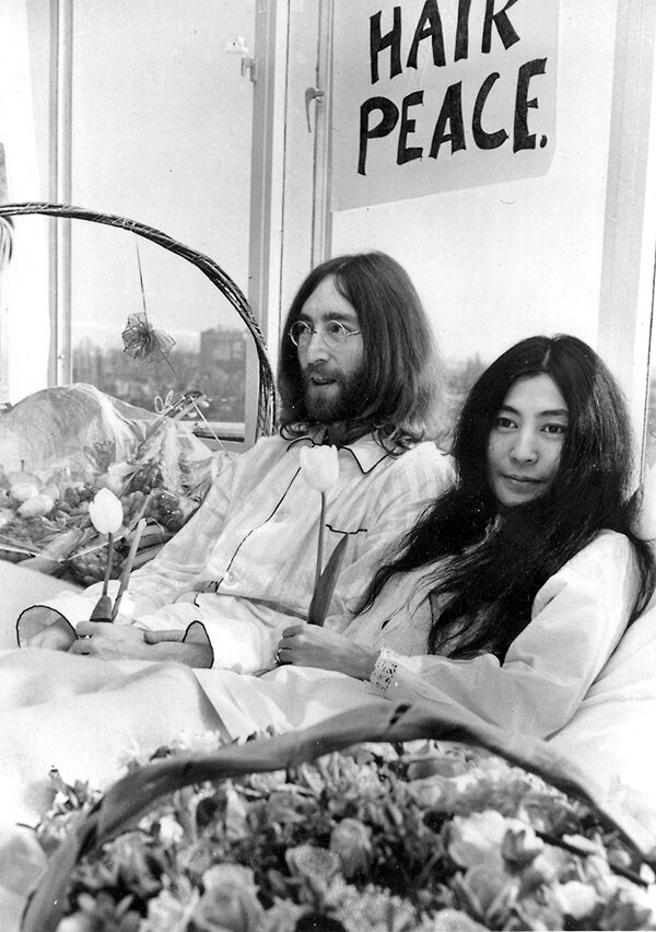 John Lennon and Yoko Ono recline on a hotel room bed in Amsterdam on their 1969 honeymoon.