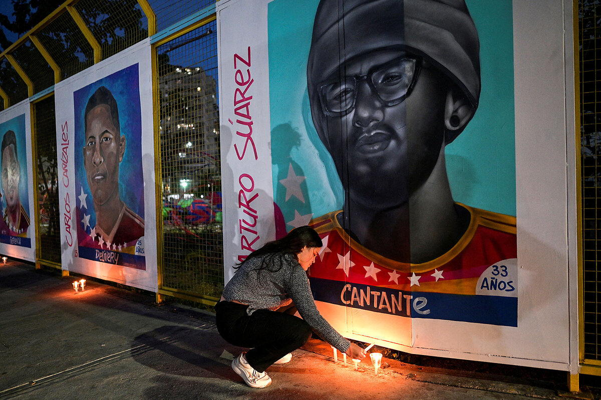 A woman lights candles in front of a mural honoring her bother, who was deported by U.S. authorities and sent to prison in El Salvador.