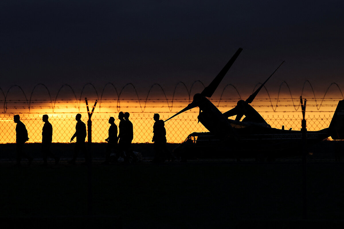 U.S. Marines walk past an MV-22 Osprey, as the sun rises at Marine Corps Base Quantico, in Quantico, Virginia, March 26, 2025. The Marine Corps is the only military branch to have passed a budgetary audit.