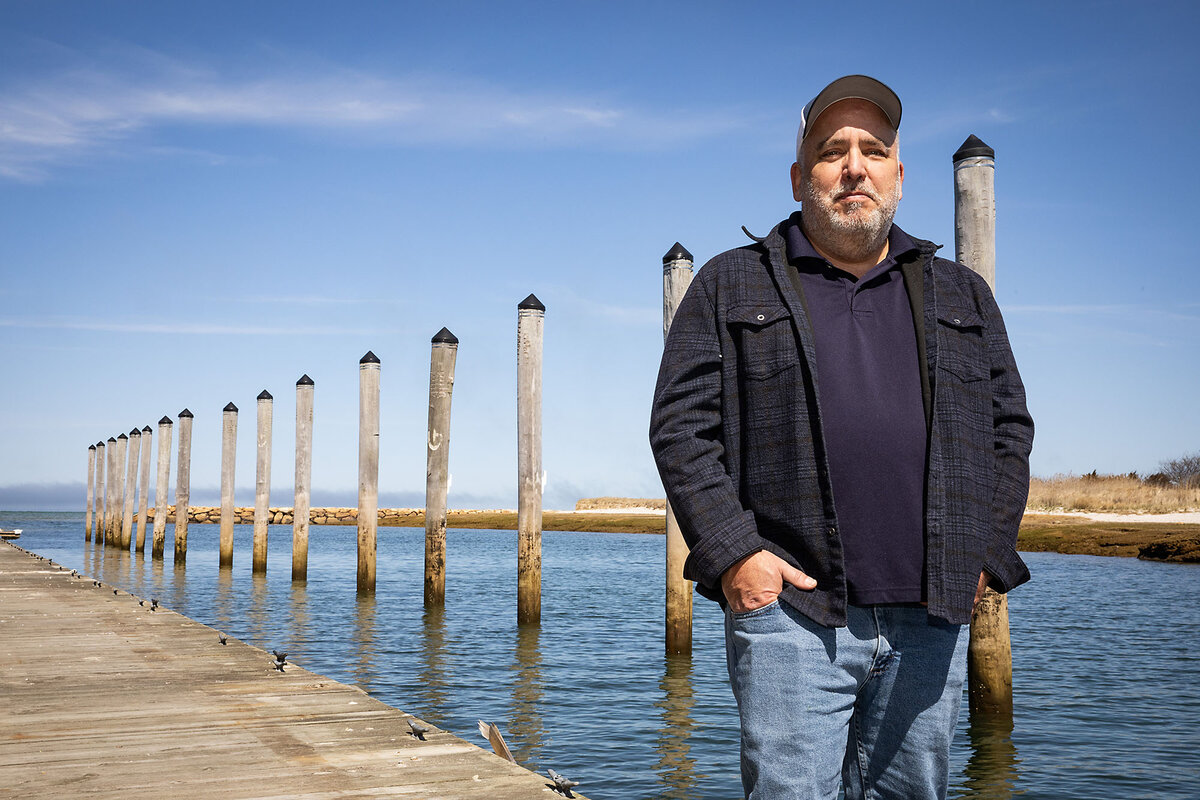 Moses Calouro stands near Cape Cod Bay, where endangered North Atlantic right whales are swimming.