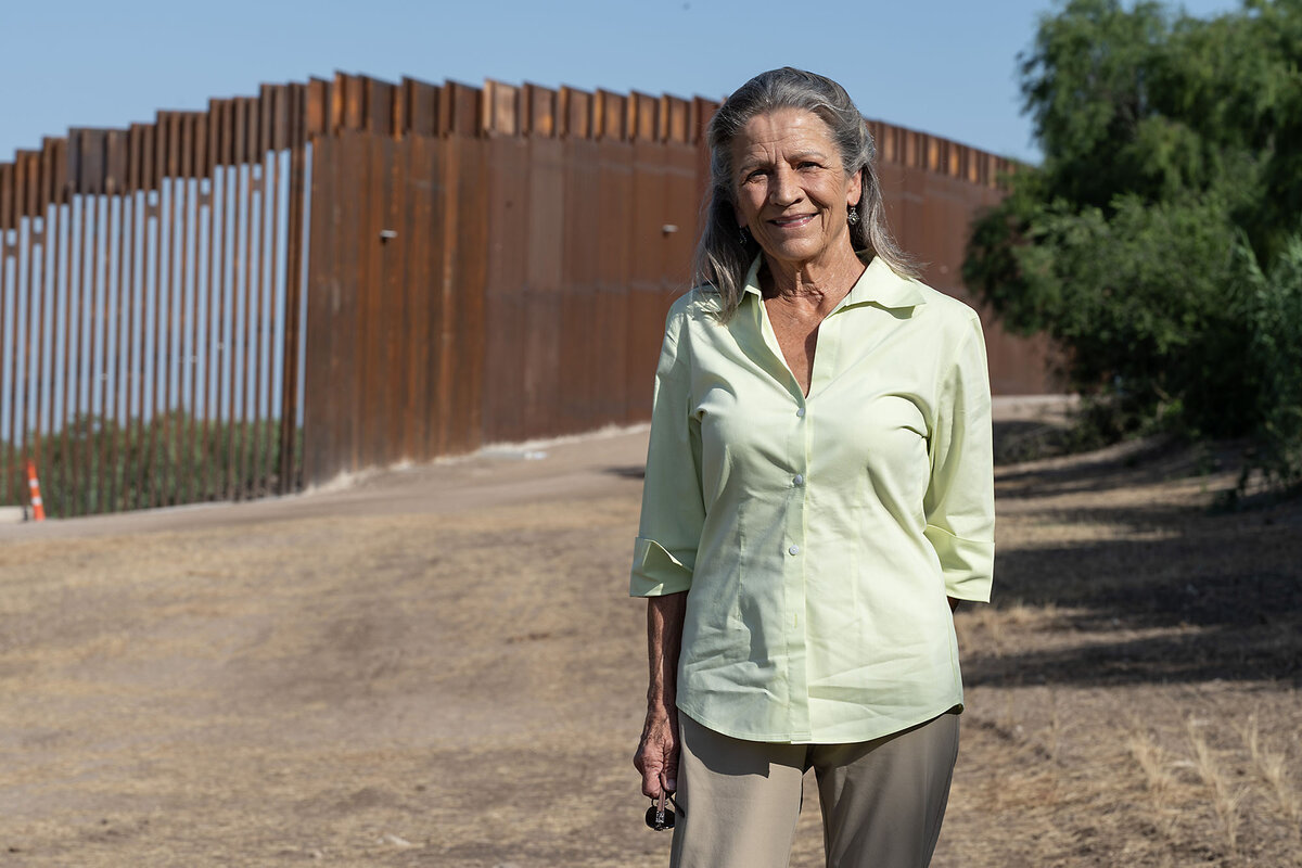 Kate Hobbs, whose family manages a watermelon farm near Normandy, Texas, stands by a border wall that the state is building on the farm. She says during the Biden administration, unauthorized immigrants flowed across the property. But in May, she said the border is more secure now.