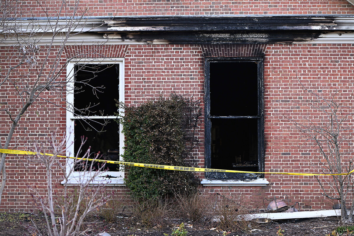 Charred wood and brick can be seen behind yellow police tape after authorities say a man set the Pennsylvania governor’s mansion on fire April 13.