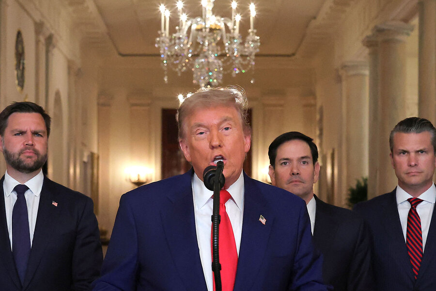 President Donald Trump with a red tie and blue suit speaks into a microphone in the White House.