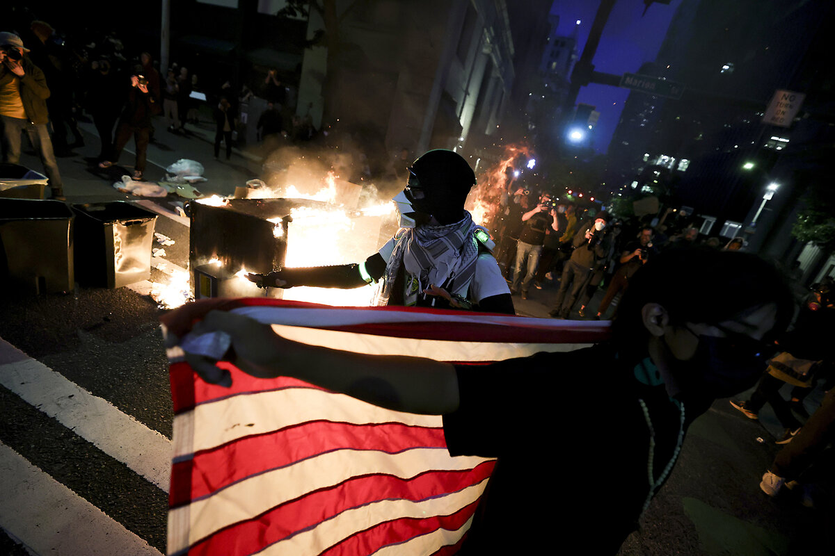 A protester reacts after being pepper-sprayed during a protest against federal immigration arrests.