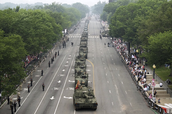 A military parade of green Army tanks rolls through Washington.