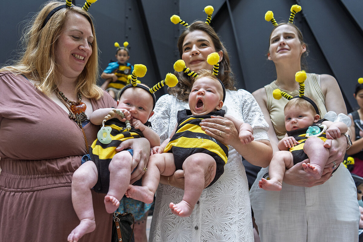 Three women and their baby daughters, who are in bee outfits, gather to oppose Medicaid cuts in President Trump's megabill.