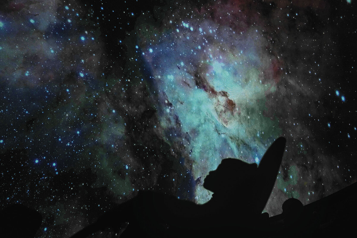 A child is silhouetted at the Iziko Planetarium in Cape Town, South Africa, Aug. 13,  2024, at an astronomy forum.