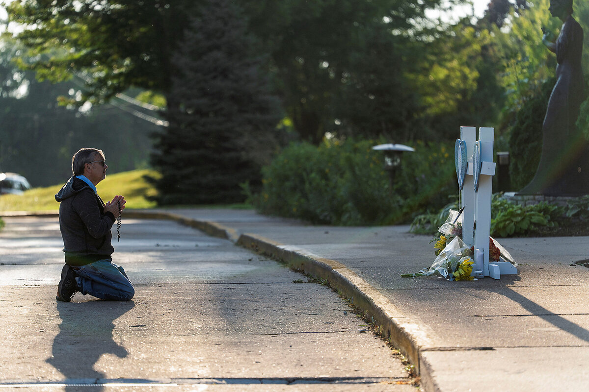 Mourner prays outside Annunciation Church