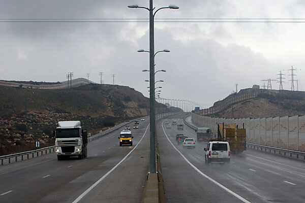 Vehicles drive on Highway 443 near the West Bank Jewish settlement of Givat Zeev, Wednesday.