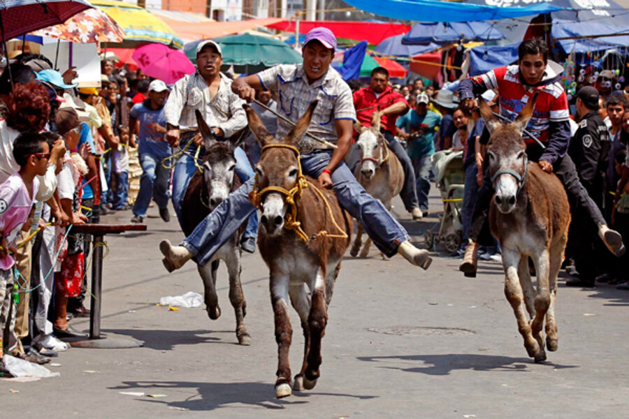 16. Riders race with their donkeys during the annual donkey festival in Otu...