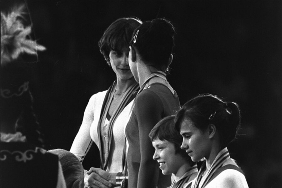 Romania's Nadia Comaneci shakes hands with Soviet gymnast Nelli Kim (b...