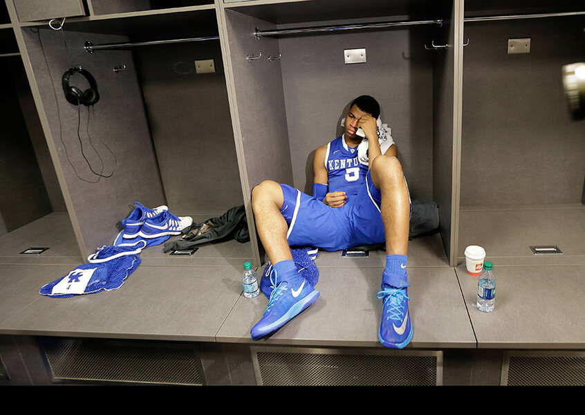 31. Kentucky guard Andrew Harrison sits in the locker room after his team&a...
