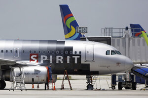 spirit checked bag fee at airport