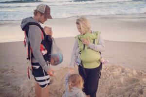 man wearing baby sling