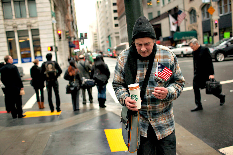 A homeless man begs for money in the financial district of San Francisco. 