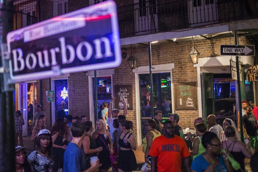 Revelers walk down Bourbon Street, located in the French Quarter of New Orl...