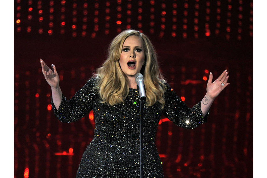 What was Adele's first song to hit number one on the Billboard Hot 100