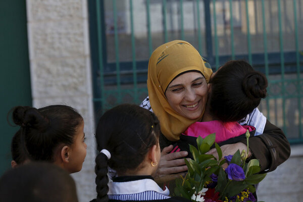 Palestinian teacher Hanan al-Hroub, who is shortlisted to win the Global Teacher Prize,is hugged by a student in the West Bank city of Ramallah February 17, 2016.