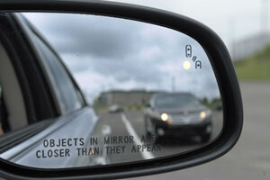 Car in rear store view mirror