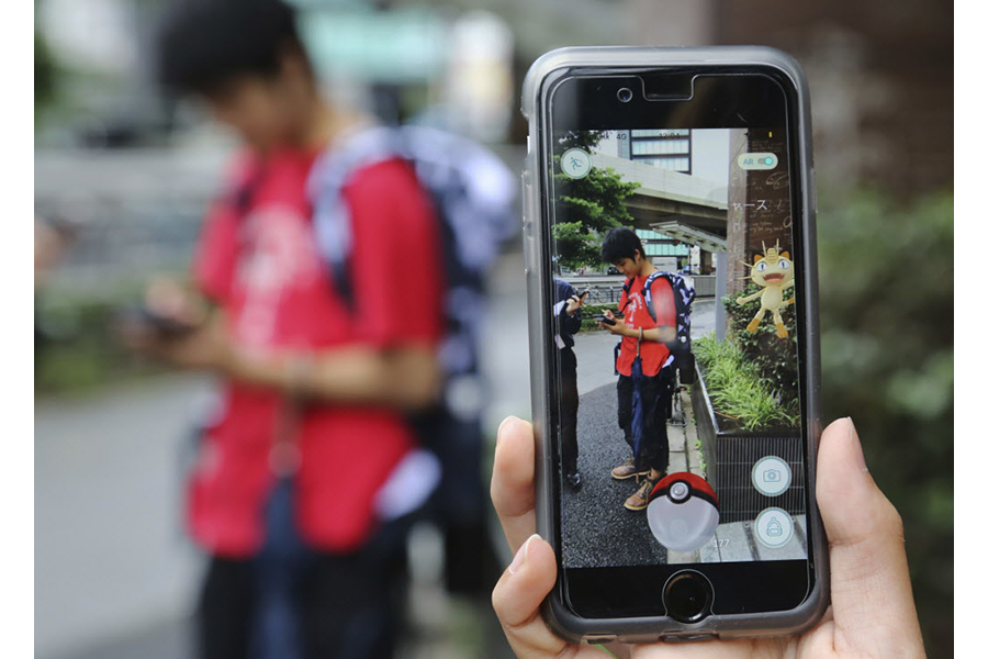 BANGKOK, Thailand - August 7, 2016: An IPhone User Playing Pokemon Go Game  In Supermarket Of Department Store And Find Pokemon Monster For Catching.  Free-to-play Augmented Reality Mobile Game Developed By Niantic.