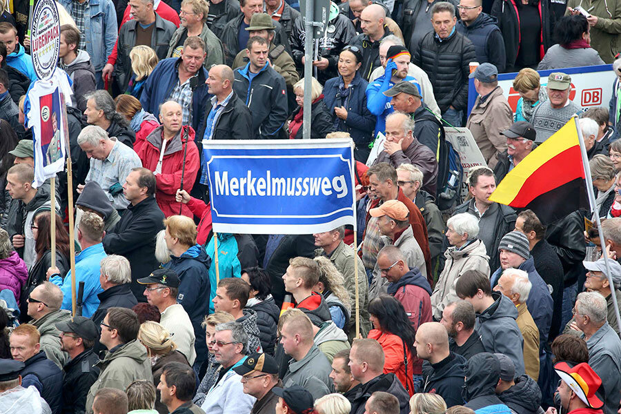 Angela Merkel faces protests on anniversary of German reunification ...