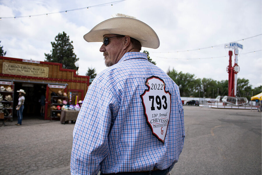 A spectator wears a floppy hat, part of a team give away for those